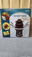 Outer box of Rival Chocolate Fountain showing branding and usage images.
