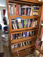 Full front view of oak barrister bookcase filled with books