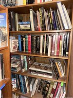 Full view of bookshelf filled with books of various subjects including rocks and minerals, erotic art, ancient civilizations, and more