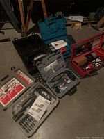 Overview of all four tool kits arranged on concrete floor
