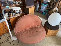Front view of burnt orange circular lounge chair