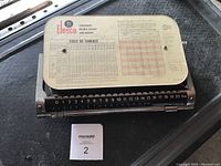 Mechanical postal scale with sliding weight and Canada Post parcel rate chart on top marked Elesco 21.