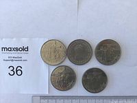 Five 1984 Jacques Cartier $1 souvenir coins arranged with measurement scale showing size.