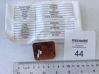 Photo showing the citrine stone with product info sheet detailing its specifications.