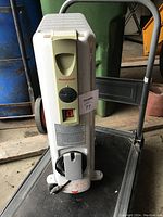 Front view of the Honeywell oil-filled radiator heater showing control panel with thermostat dial, power switch, and power cord storage.