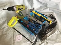 Photo showing various tools including Ridley cordless drill, reciprocating saw, angle grinder, adjustable wrenches, scissors, and hacksaw taken together in one lot.