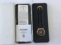 Watch in black foam insert inside white box with warranty booklet and MaxSold label