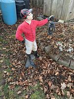 Front view showing full statue holding lantern