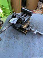 View of the pivot machinist vice showing full vice with screw handle and pivot mechanism on a metal table.