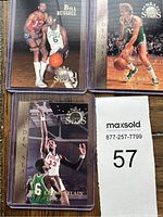 Three Topps Stars Golden Season cards front view in protective sleeves: Bill Russell, Larry Bird, Wilt Chamberlain