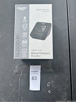 Front view of the boxed Equate 6000 Series wireless upper arm blood pressure monitor showing brand, product image, and features.