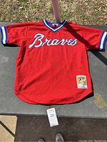 Front view of red Atlanta Braves baseball jersey showing Braves lettering and Cooperstown Collection patch.