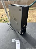 Side view of Dell desktop computer tower showing logo and surface wear.