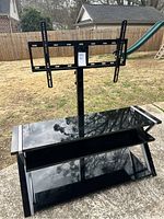 Front view of black tempered glass top and lower shelf with central mount