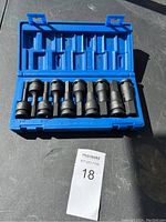 Blue plastic case with 8 black hex driver sockets arranged inside, labeled sizes visible from 1/4" to 7/16".