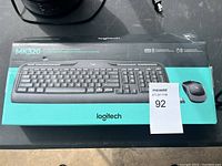 Photo of the Logitech MK320 keyboard and mouse combo original box showing product image and branding