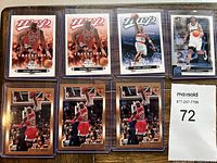 Eight Michael Jordan basketball cards displayed in protective sleeves on a surface.