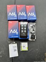Five boxed Nuu Mobile A6L phones with one phone displayed out of box along with charger, USB cable and individual battery package.