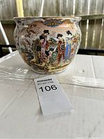 Front view of the Chinese bowl showing the painted figures of women in traditional attire with floral patterns and ornamental design.