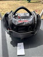 Front view of gray and black Ugly Stik tackle bag with logo visible on front pocket, showing the padded handle and red zipper pulls showcasing the bag condition.
