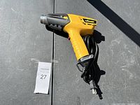 Yellow Wagner heat tool shown from side with power cord coiled.