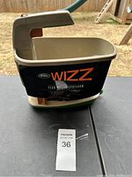 Front and side view of the Scotts Wizz spreader showing branding and handle trigger