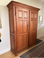 Full front view of antique pine cabinet in room setting