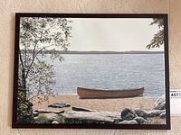 Full view of framed canvas painting showing canoe, lake, trees, rocks and frame