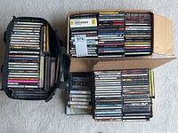 Various classical and jazz CDs stacked in soft and cardboard cases