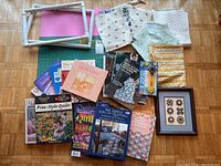 Overview photo of the quilting lot showing fabrics, books, quilting frame, rotary cutter, and framed art