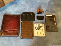 Stationery lot including leather notebooks, bookmarks, wallet, pouch and book plates.