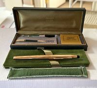 Full view of the fountain pen displayed on green velvet pouch with original box and accessories in the background.