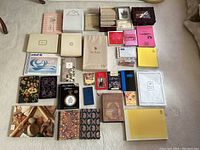 Overview of the full collection showing multiple boxes and packs of vintage stationery, notebooks, and envelopes arranged on floor