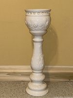 Front view of two-piece white ceramic jardinière planter on pedestal stand