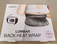 Front of the box showing the product name 'VitalBliss Lumbar Back Heat Wrap', microwaveable feature, and lavender scent.