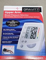 Front of the sealed box for Gravitti Upper Arm Blood Pressure Monitor HL868ZA showing product image and key features.