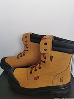 Side view of tan leather King Threads men's work boots with black toe reinforcement and black padded collar.