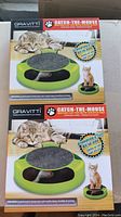 Two unopened Gravitti Catch-The-Mouse cat toys showing front packaging with images of cats playing and the toy's features.