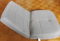 Angled side view showing the fold and cushioned texture of the gray cozy gaming chair.