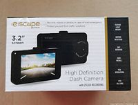 Front of box showing 3.2 inch screen dash camera with high definition and cycled recording features
