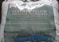 Photo of pillow packaging labeling showing details: 2 pack, 100% duck feather filling, queen size 20 x 28, made in Canada, features for side sleepers, washable, hypoallergenic.
