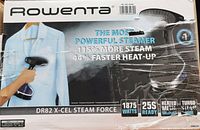 Front view of the Rowenta steamer box showing branding and key features such as powerful steam, faster heat-up, wattage, and ready time.