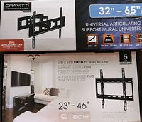 Photo of two TV mounts in opened boxes showing front of packaging with specifications and features.
