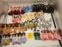 All 51 Madame Alexander Wizard of Oz dolls grouped together showing different characters and costumes including witches, flying monkeys, Munchkins, Dorothy, and others.