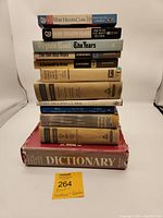 Stack of 11 books showing variety of titles and conditions, including paperbacks and hardcovers.