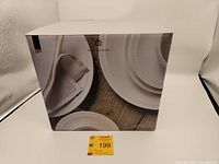 Box front showing the Eaton Fine Dining brand and embossed white porcelain tableware with decorative rim.