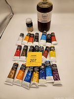 Photo showing Gamblin Galkyd 946ml bottle, Grumbacher Cobalt Drier 74ml, and an assortment of Winsor & Newton water mixable oil paint tubes with a yellow sticky note marker.