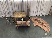 Full set of fireplace accessories including brass finish tools, andirons, log holder with logs, decorative Asian wooden fan, and brass finish wood box