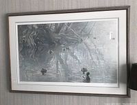 Full view of framed and matted Robert Bateman limited edition print depicting ducks on water beneath twisted tree roots.