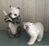 Front view of both Lladro bears - Panda holding bamboo and standing Polar Bear.